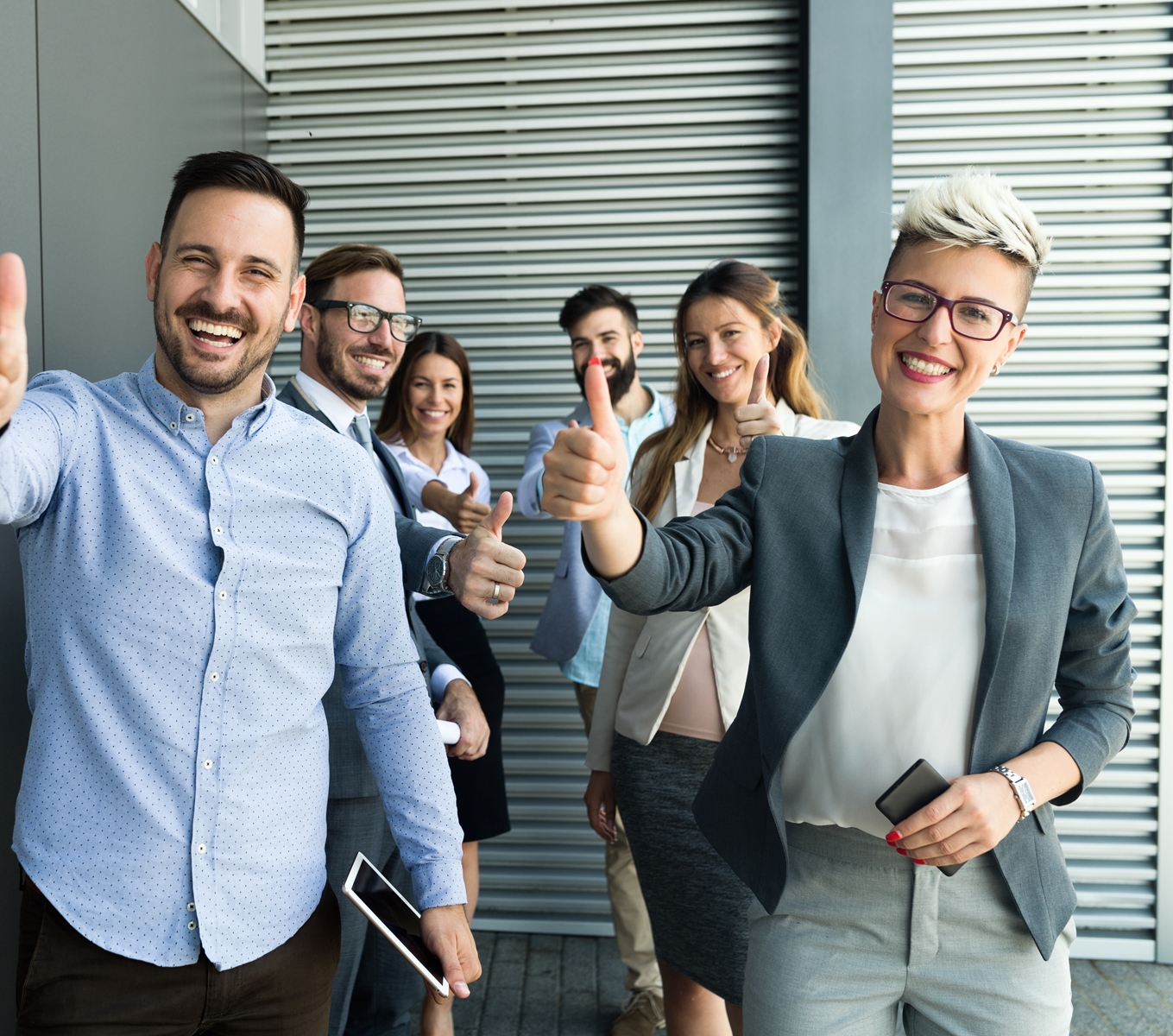 Business people giving a thumbs up